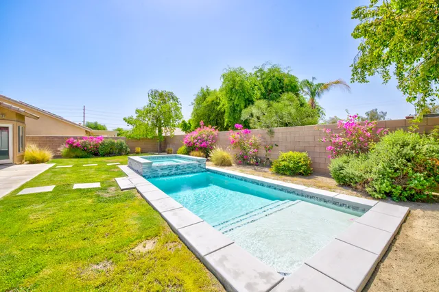 a view of garden with flowers and trees