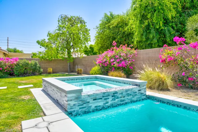 a view of a potted flower in a yard with swimming pool