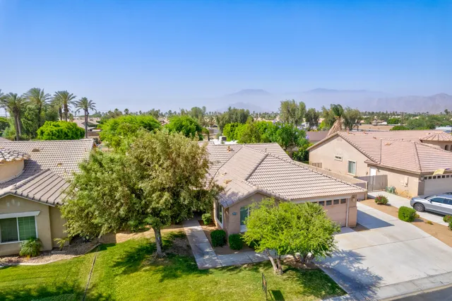 an aerial view of a house with yard and outdoor seating