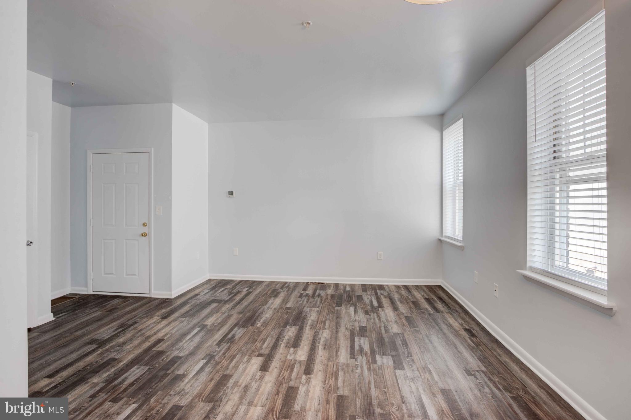 951 Brooks Lane, Unit 1C Baltimore, MD 21217 - Photo 5 of 21 a view of a room with wooden floor and window