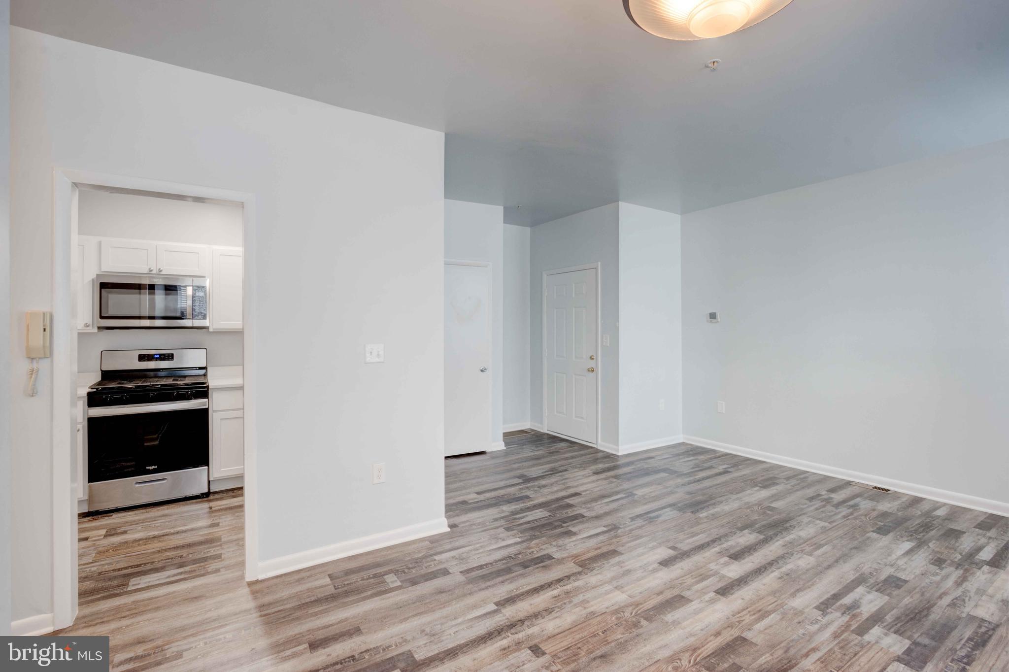 951 Brooks Lane, Unit 1C Baltimore, MD 21217 - Photo 6 of 21 a view of a kitchen space with wooden floor
