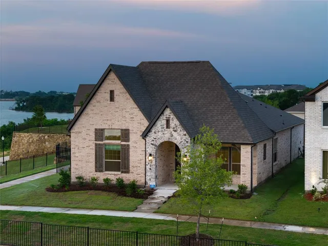 a front view of a house with yard and green space