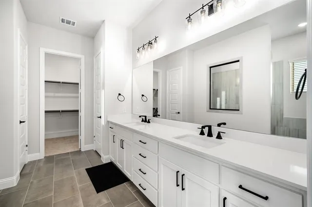 a spacious bathroom with a shower and a sink