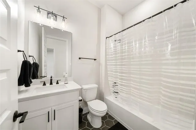 an empty room with windows and entrance