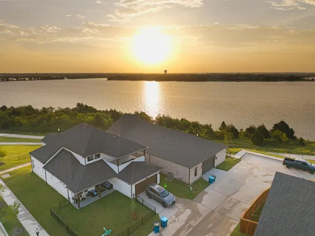 an aerial view of a house with a lake view