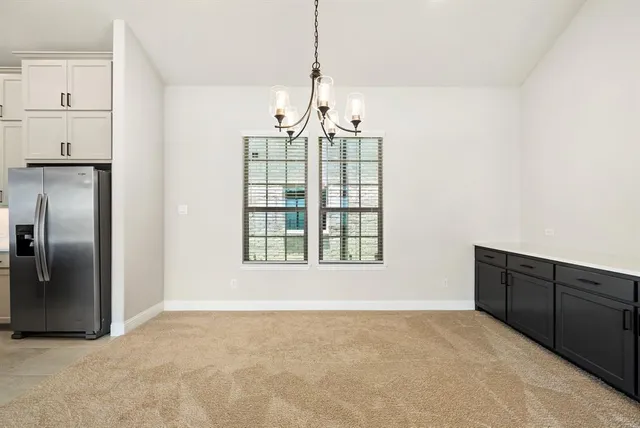 a large kitchen with kitchen island a large counter top a sink and stainless steel appliances