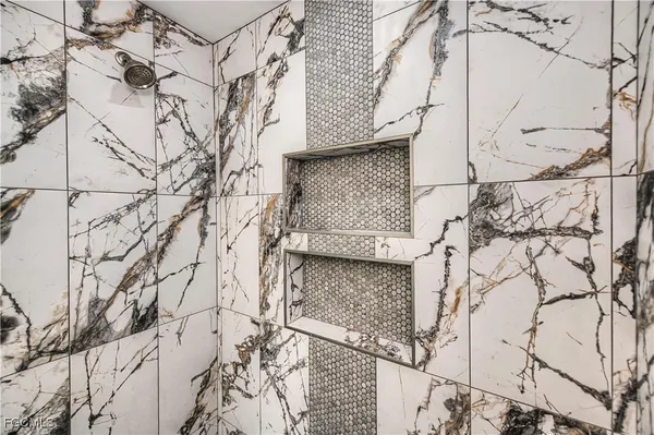 an empty room with window and ceiling fan