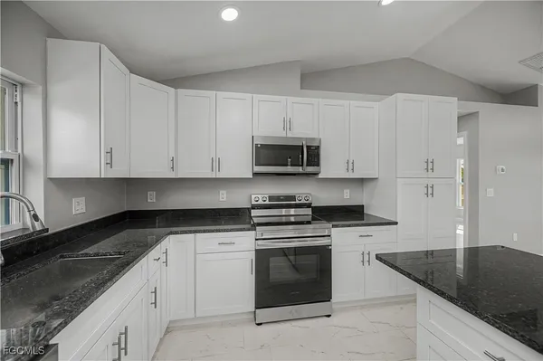 a kitchen with kitchen island a granite counter top and a center island