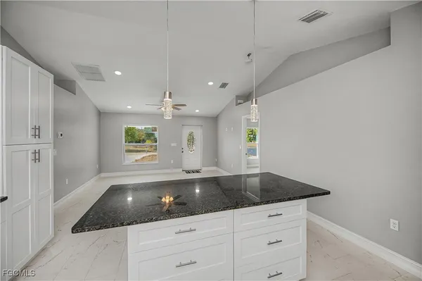 a kitchen with stainless steel appliances granite countertop a sink a stove and a refrigerator