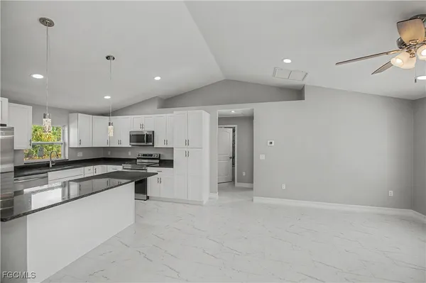 a kitchen with stainless steel appliances a refrigerator sink and stove