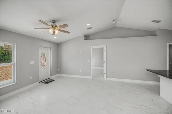 a kitchen with stainless steel appliances granite countertop a refrigerator sink and stove