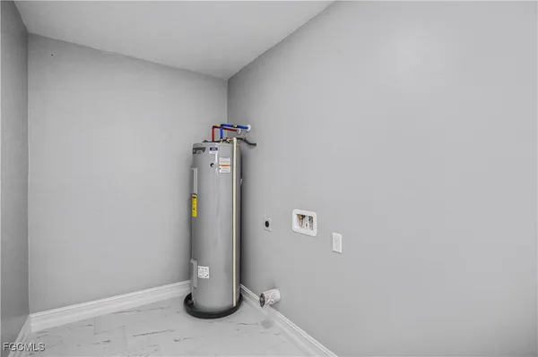 a view of water heater and utility room