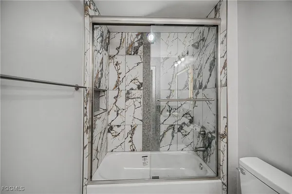 a bathroom with a bathtub and shower curtain