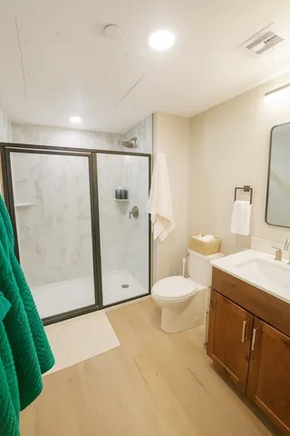 a bathroom with a sink toilet and shower