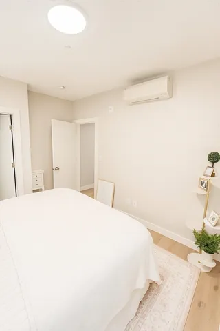 a bedroom with a bed and a mirror