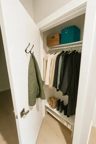 a view of walk in closet with clothes and shoes