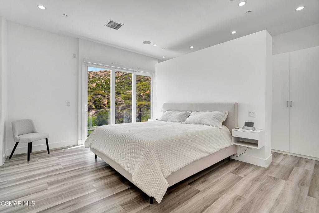 990 Alta Vista Road Simi Valley, CA 93063 - Photo 12 of 36 a large white bed sitting in a room next to a window