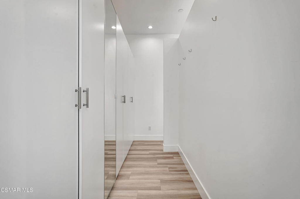 990 Alta Vista Road Simi Valley, CA 93063 - Photo 15 of 36 a view of a hallway with wooden floor and a staircase