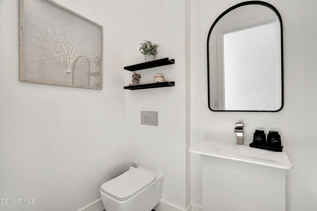 990 Alta Vista Road Simi Valley, CA 93063 - Photo 16 of 36 a white toilet sitting next to a bathroom sink