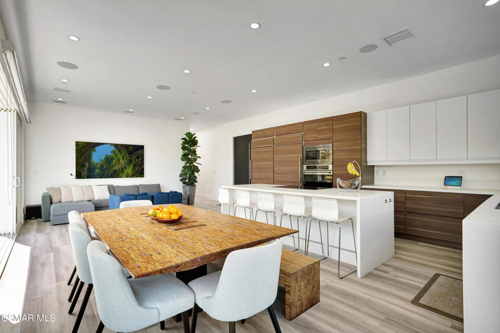 990 Alta Vista Road Simi Valley, CA 93063 - Photo 7 of 36 a kitchen with kitchen island a dining table and chairs in it