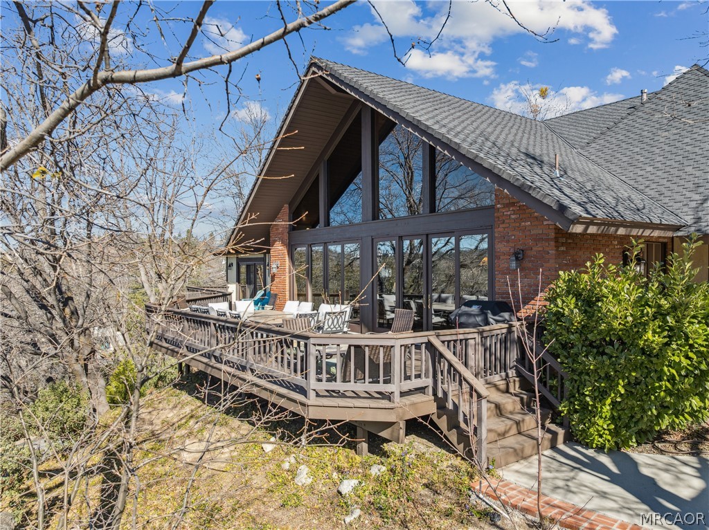 a view of a roof deck with wooden fence and plants