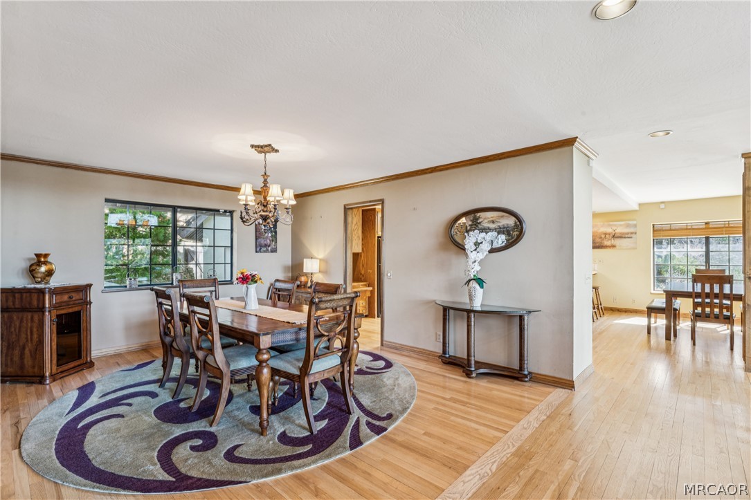28994 North Shore Road Lake Arrowhead, CA 92352 - Photo 16 of 50 a dining room with furniture a chandelier and wooden floor
