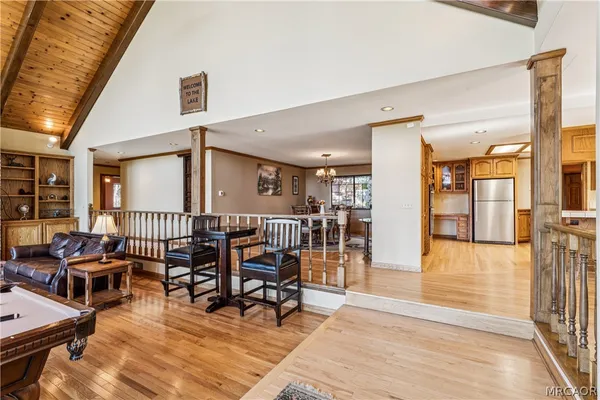 a dining hall with stainless steel appliances granite countertop a stove and a refrigerator