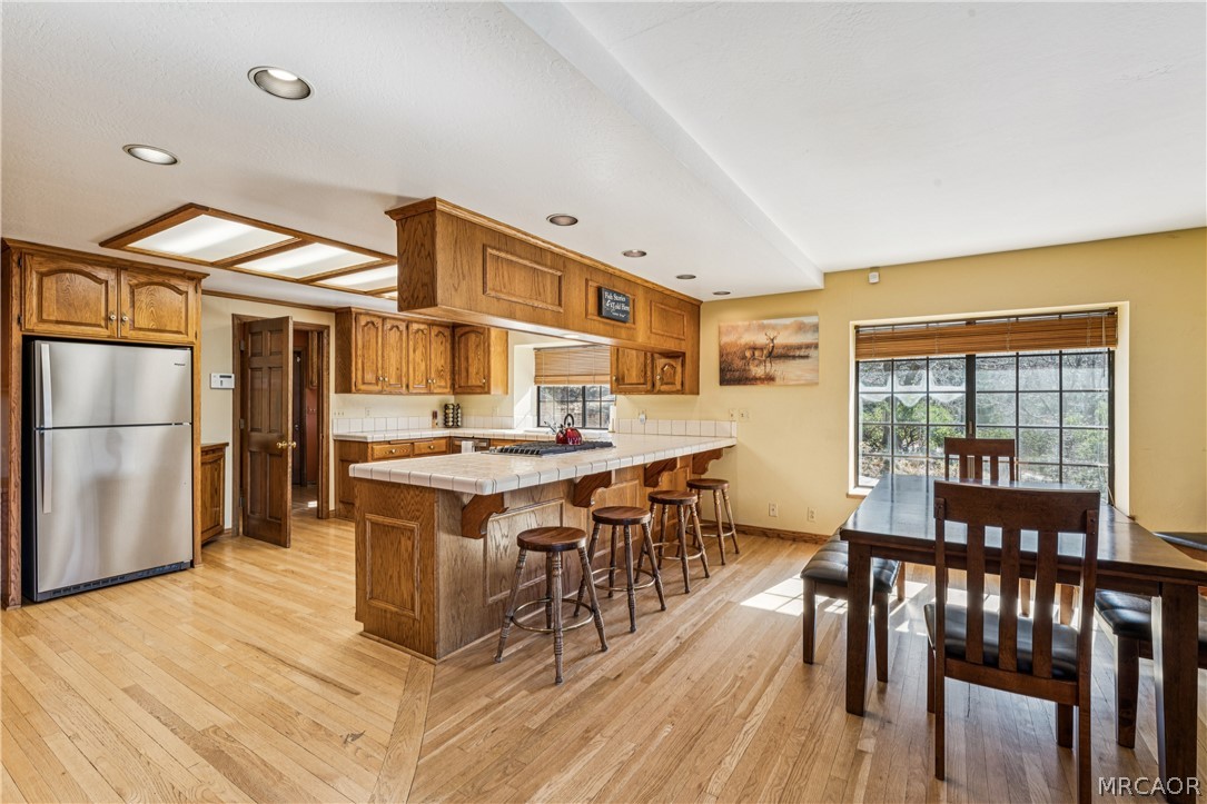 28994 North Shore Road Lake Arrowhead, CA 92352 - Photo 19 of 50 a dining hall with stainless steel appliances granite countertop a stove and a refrigerator