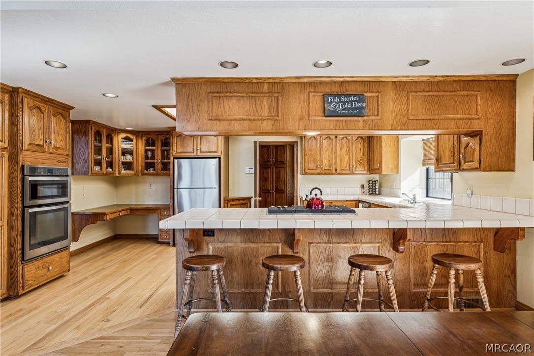 28994 North Shore Road Lake Arrowhead, CA 92352 - Photo 20 of 50 a large kitchen with a table and chairs in it