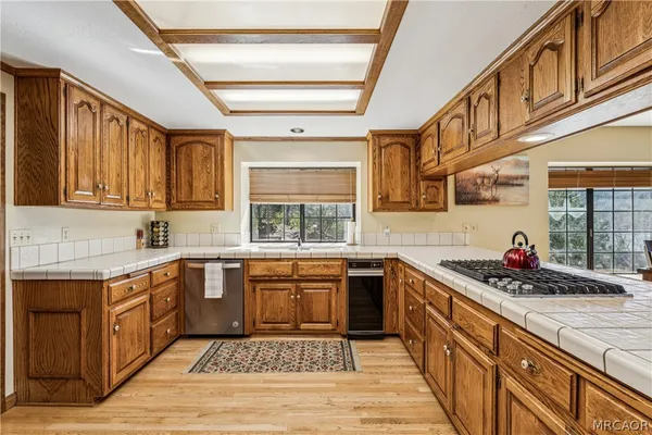 a kitchen with stainless steel appliances granite countertop a sink and cabinets