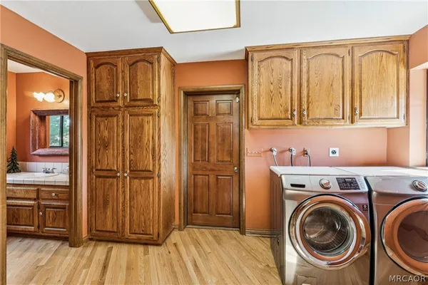 a spacious bedroom with a bed a couch and a large window