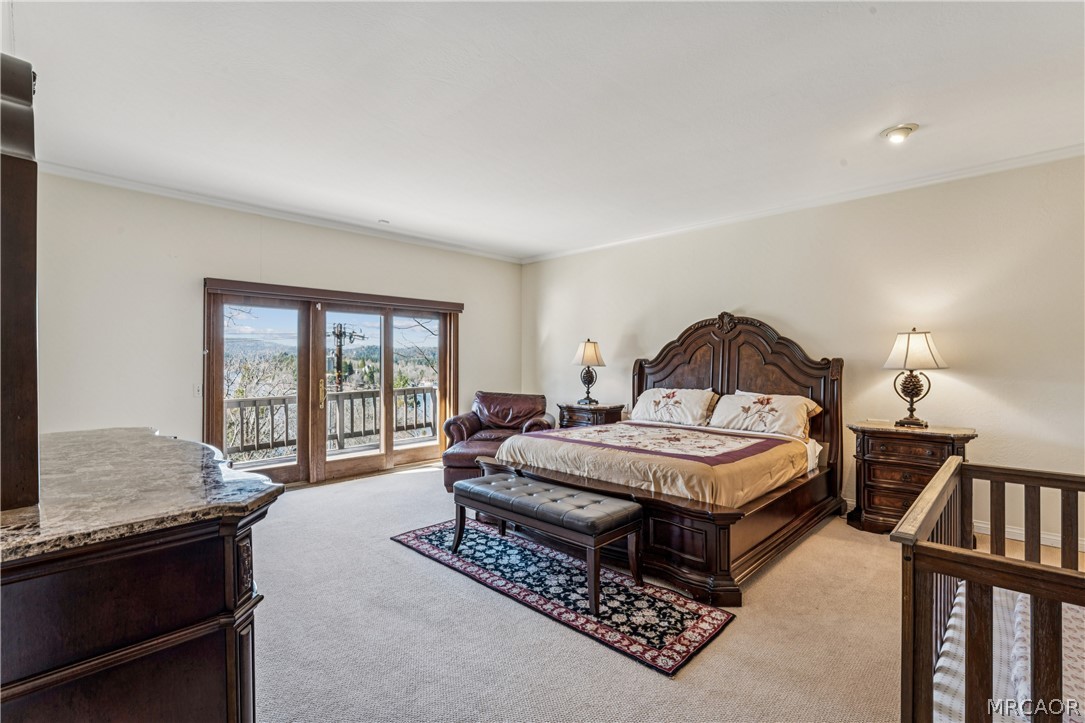 28994 North Shore Road Lake Arrowhead, CA 92352 - Photo 25 of 50 a spacious bedroom with a bed a couch and a large window