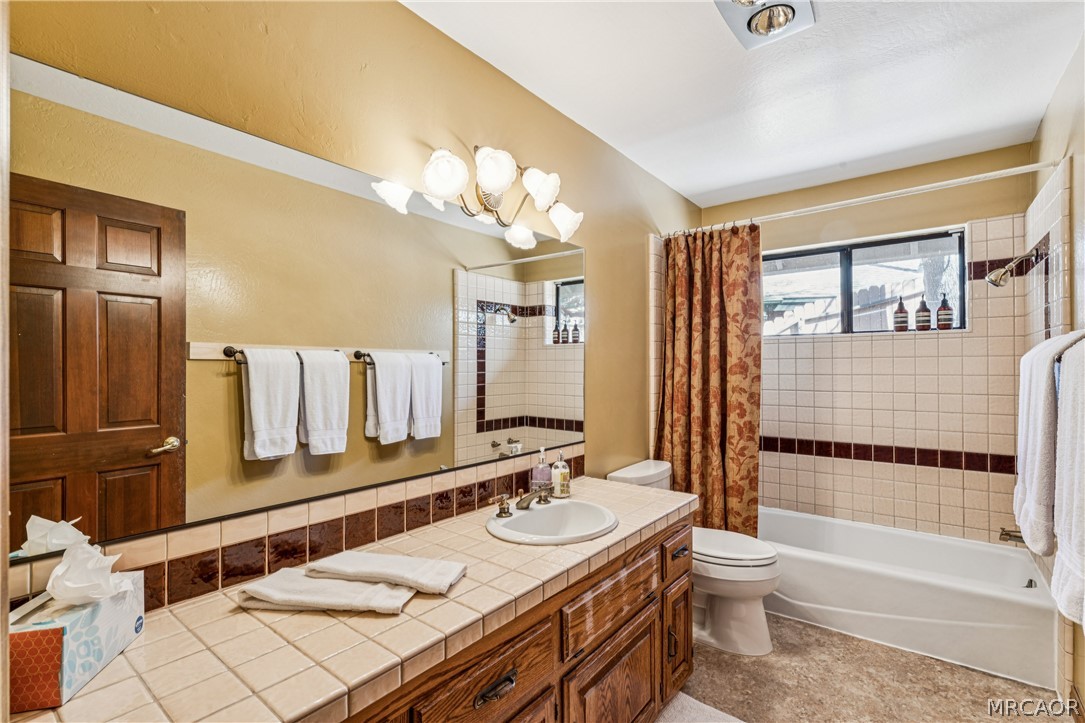 28994 North Shore Road Lake Arrowhead, CA 92352 - Photo 34 of 50 a bathroom with a granite countertop sink and a mirror