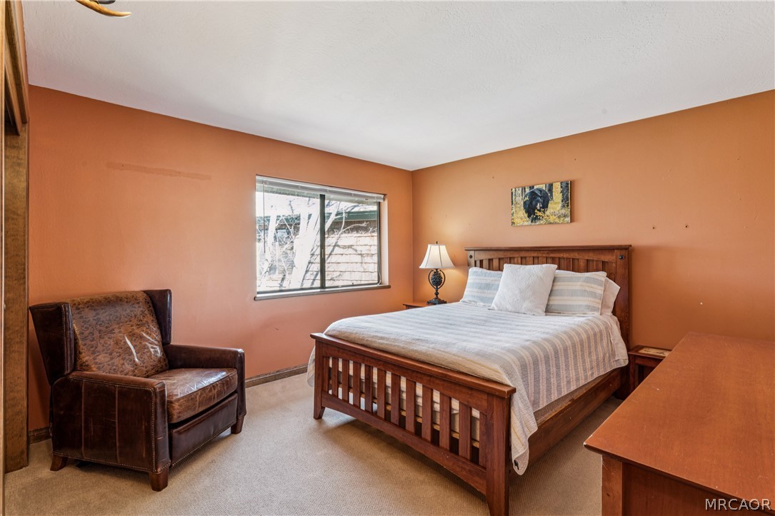 28994 North Shore Road Lake Arrowhead, CA 92352 - Photo 35 of 50 a bedroom with a bed window and couch