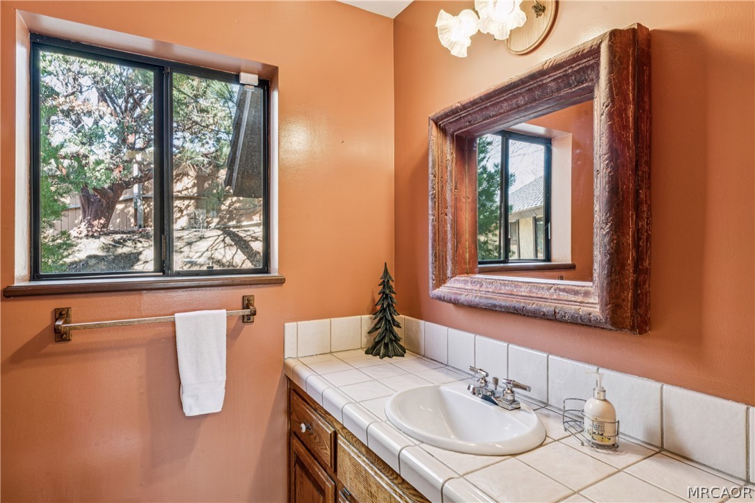28994 North Shore Road Lake Arrowhead, CA 92352 - Photo 36 of 50 a bathroom with a sink vanity and mirror