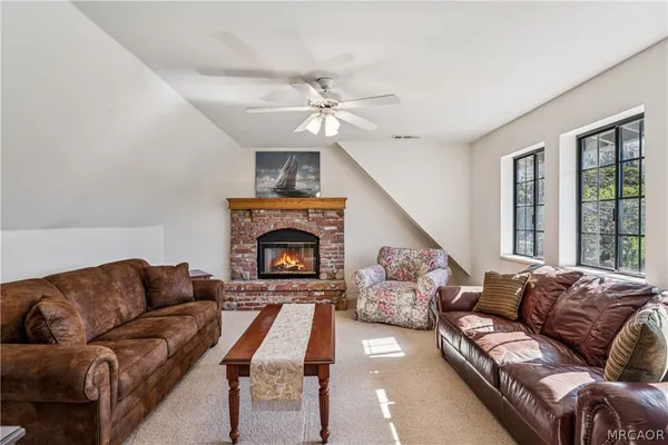 a view of a roof deck with table and chairs with wooden floor and fence
