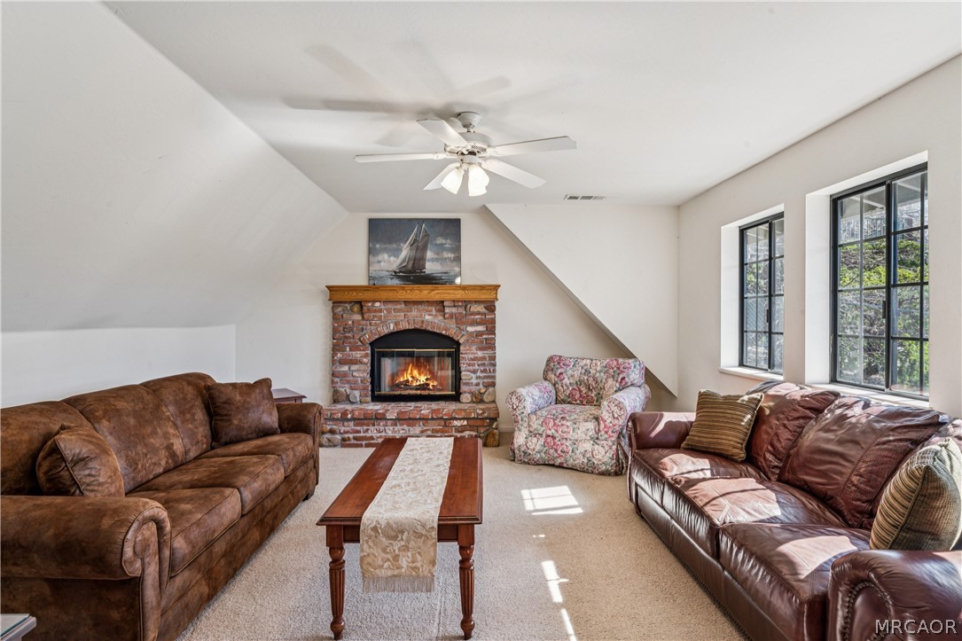 28994 North Shore Road Lake Arrowhead, CA 92352 - Photo 38 of 50 a living room with furniture and a fireplace