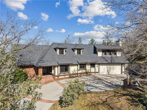a view of a house with a yard and sitting area