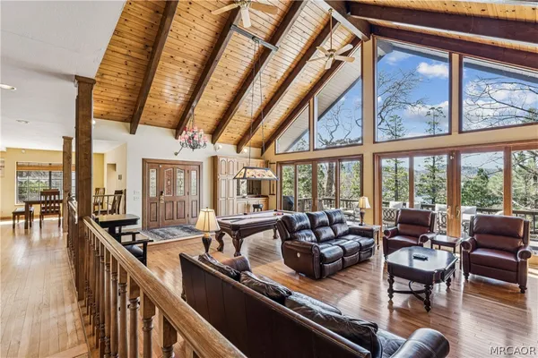 a living room with furniture and floor to ceiling windows