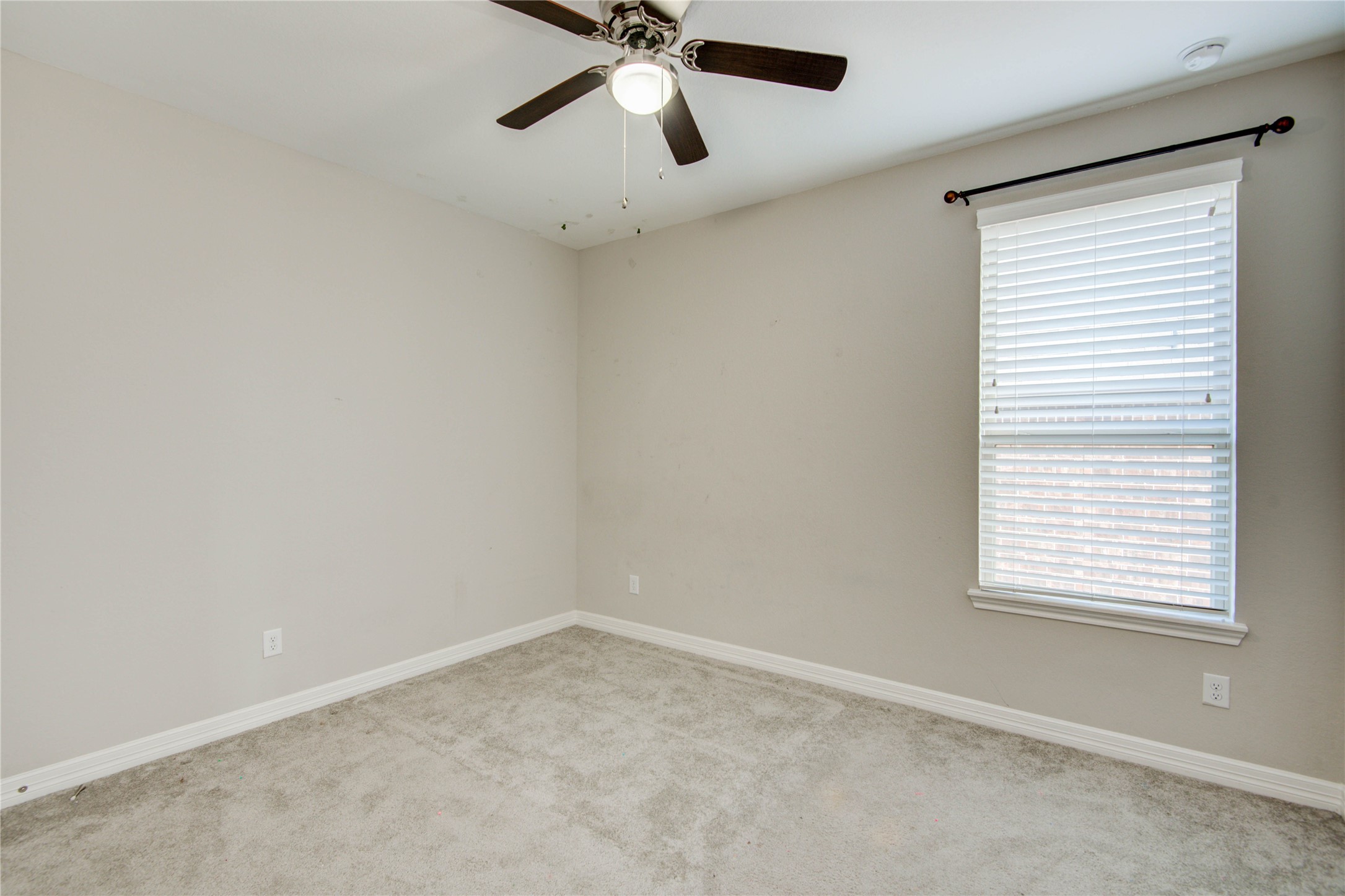 23527 San Ricci Court Richmond, TX 77406 - Photo 19 of 37 an empty room with a window and a fan