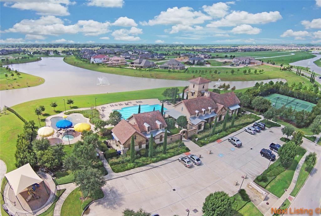23527 San Ricci Court Richmond, TX 77406 - Photo 32 of 37 an aerial view of a city with lots of residential buildings ocean and mountain view in back