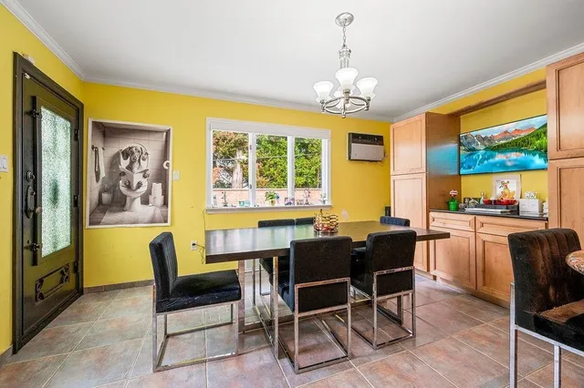 a view of a dining room with furniture a chandelier and wooden floor