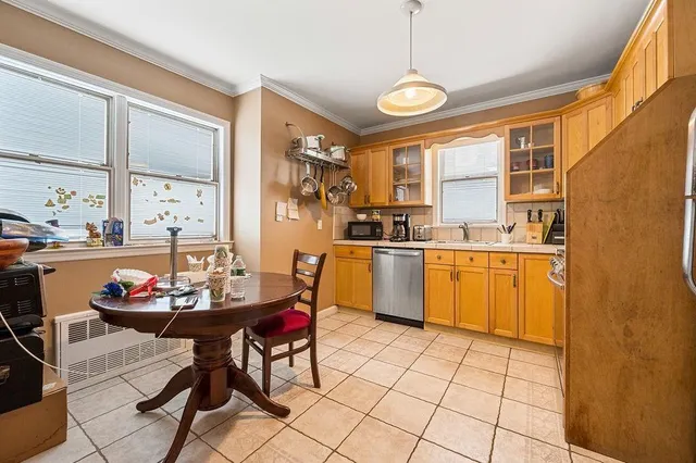 a kitchen with a sink a stove a dining table and chairs