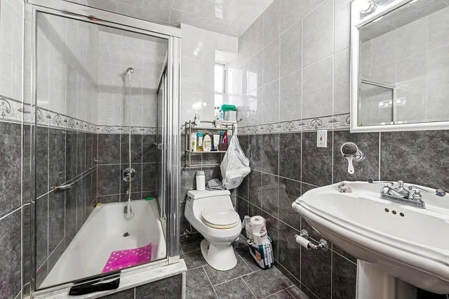 a bathroom with a sink toilet and shower