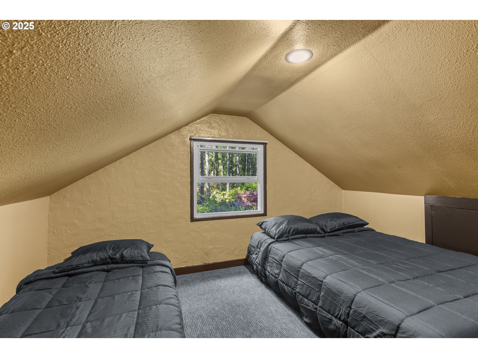 24082 East Decatur Road Welches, OR 97067 - Photo 17 of 44 a bedroom with a bed and a painting on the wall