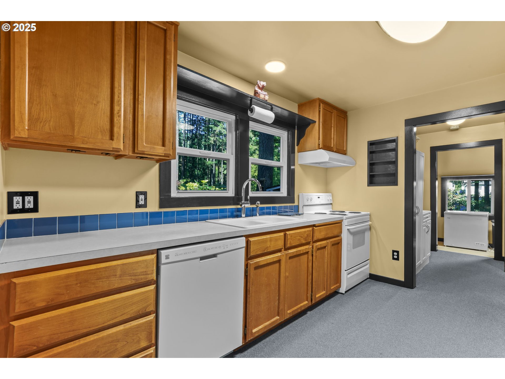 24082 East Decatur Road Welches, OR 97067 - Photo 9 of 44 a kitchen with a sink and dishwasher with wooden floor
