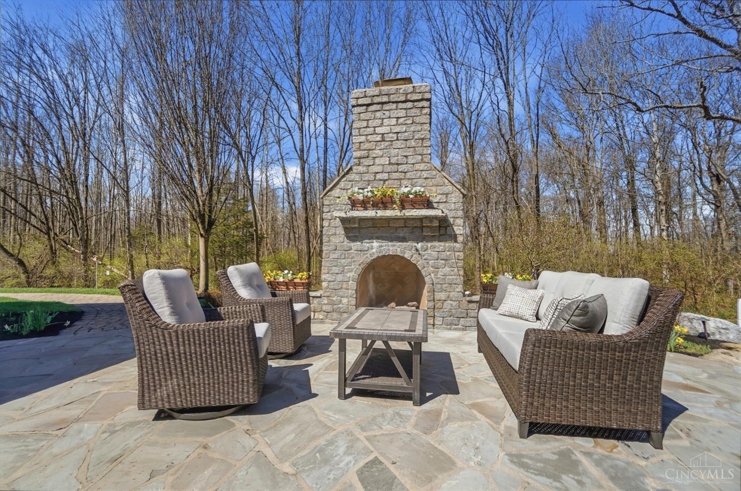 1054 Observatory Point Maineville, OH 45039 - Photo 66 of 82 Look at that wooded backyard, 7th fireplace and field stone patio.