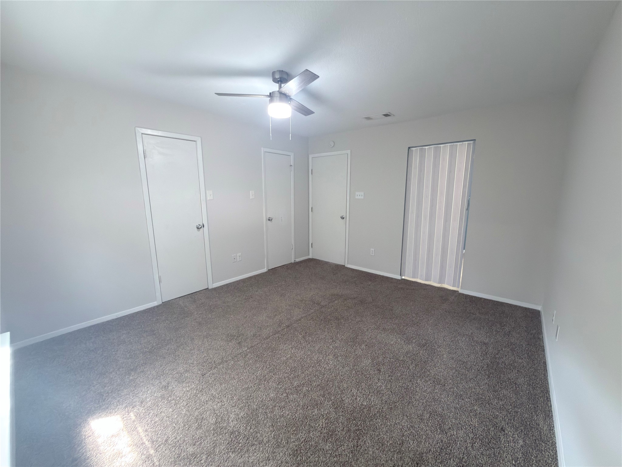2018 West Rundberg Lane, Unit 6A Austin, TX 78758 - Photo 12 of 16 Main bedroom,with soft carpeting and ceiling fan. window facing back patio.