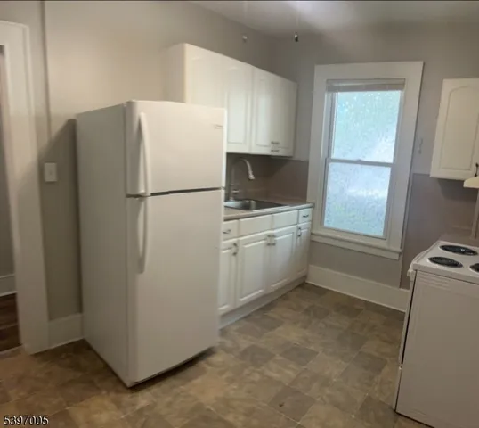 a white refrigerator freezer sitting in a kitchen