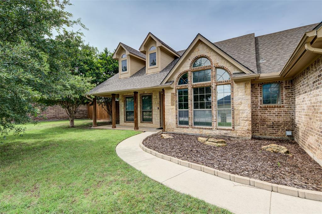 2105 Ridgewood Drive Bridgeport, TX 76426 - Photo 2 of 27 Attractive brick and stone exterior with mature landscaping and driveway.